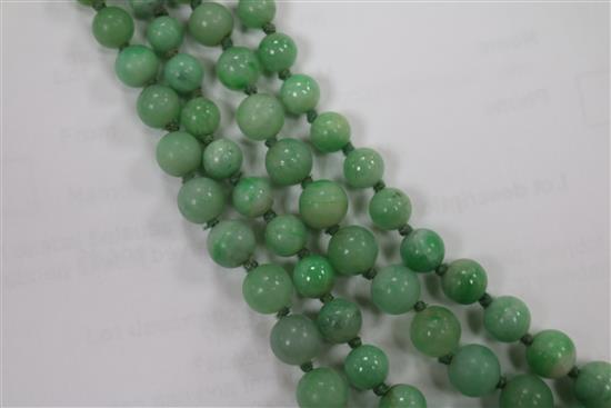 A double strand graduated jadeite bead necklace with carved jadeite pendant, pendant 29mm.